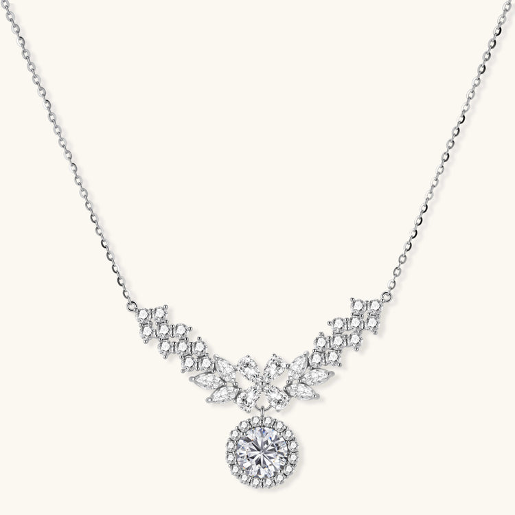 Elegant sterling silver necklace featuring intricate wing-like design with brilliant moissanite stones on neutral background.