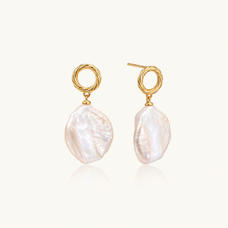 18K gold vermeil twisted circle studs with organic white baroque pearl drops on cream background
