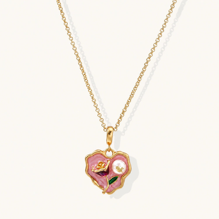 Heart-shaped pendant with pink enamel, rose design, freshwater pearl flower, and gold scalloped frame on delicate chain