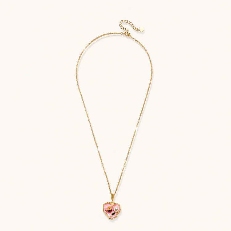 Heart-shaped pendant with pink enamel, rose design, freshwater pearl flower, and gold scalloped frame on delicate chain