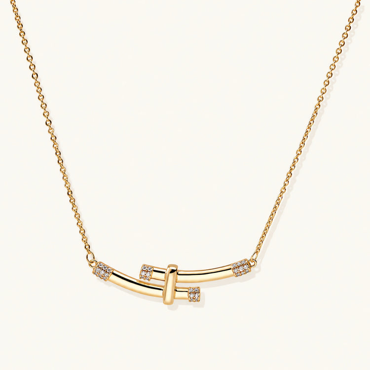 Gold-plated curved bar necklace with diamond accents on delicate chain against cream background