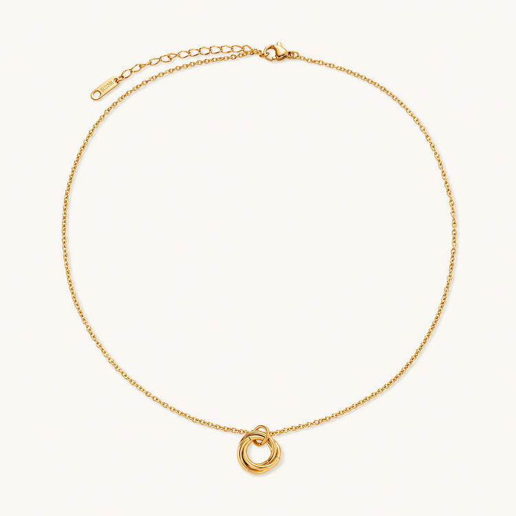 Delicate gold-plated necklace with three interlocking circle rings forming a minimalist knot pendant on cream background