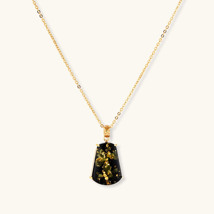 18k gold-plated necklace and earrings with green amber pendants featuring golden inclusions on cream background